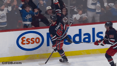 Hockey Player Number 64 In Front Of Esso Ad GIF