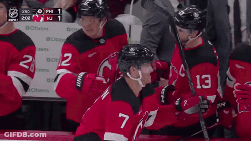 Hockey Player Number 7 Hugging Another Player GIF