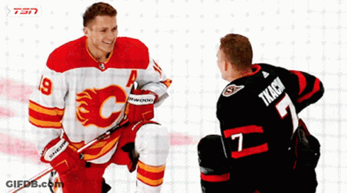 Hockey Player Number 7 Talking To Another Player GIF