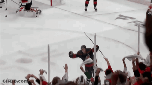 Hockey Player Number 8 Surrounded By Fans GIF