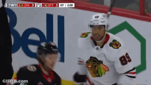 Hockey Player Number 84 In Front Of Bell Ad GIF