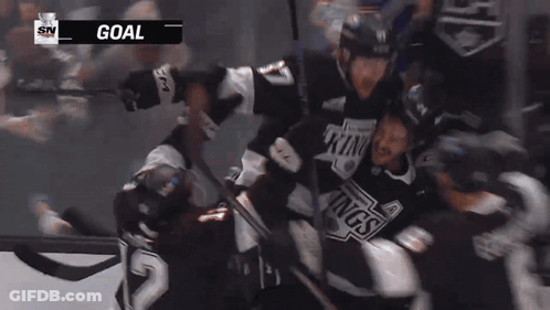 Hockey Player Number 84 Surrounded By Teammates GIF