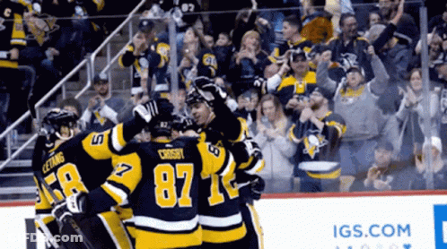 Hockey Player Number 87 Surrounded By Teammates GIF
