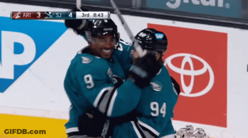 Hockey Player Number 94 Hugging Another GIF