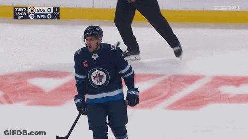 Hockey Player On Ice With Puck And Scoreboard 7:37 GIF