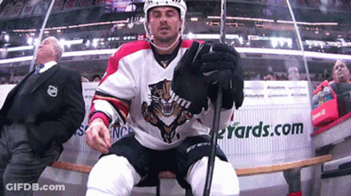 Hockey Player Sitting On Bench In Front Of Yards.com Sign GIF