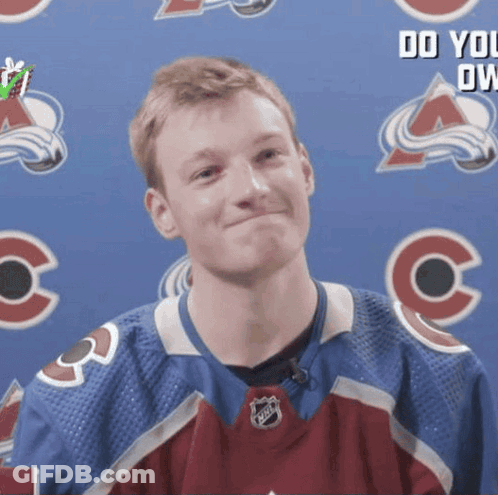Hockey Player Smiling In Front Of Banner GIF