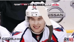 Hockey Player Smiling Near Nissan Advertisement GIF