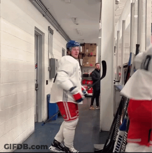 Hockey Player Standing Next To Bauer Stick GIF