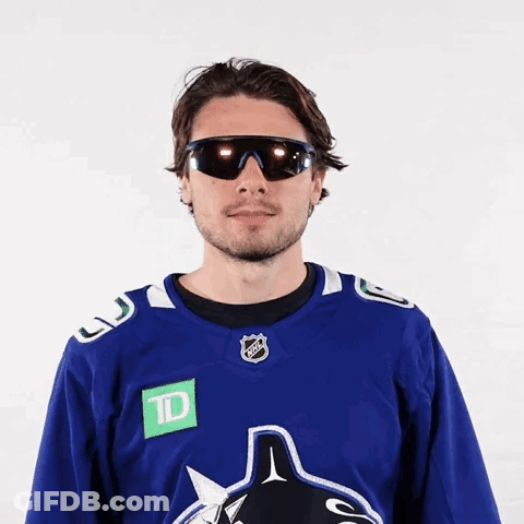Hockey Player Wearing Sunglasses And Blue Jersey GIF