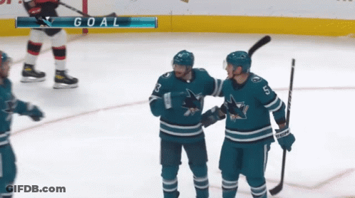 Hockey Players Celebrating Goal With Goal Scoreboard GIF
