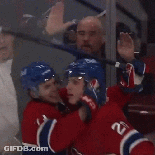 Hockey Players Celebrating Goal With Puck GIF