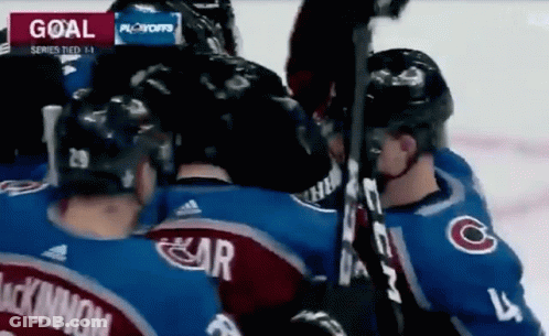 Hockey Players Huddled Near Goal GIF