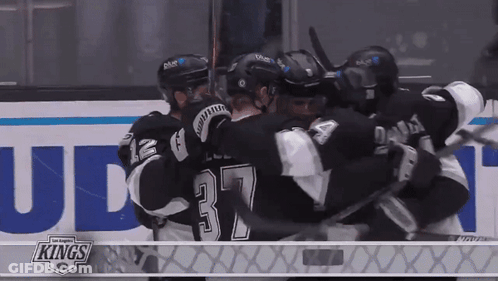 Hockey Players Hugging In Front Of Kings Ad GIF