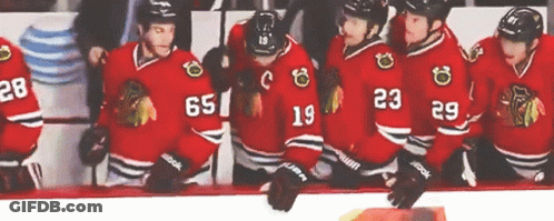 Hockey Players In Red Jerseys Number 65 GIF