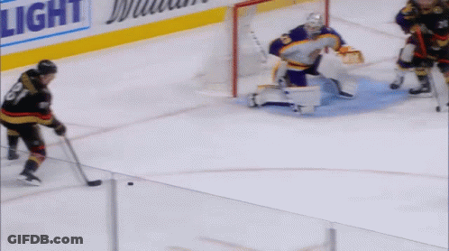 Hockey Players On The Ice With A Light Advertisement In The Background GIF