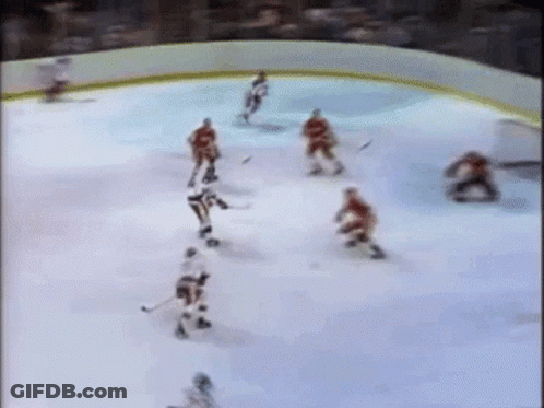 Hockey Players Playing On Ice Rink GIF