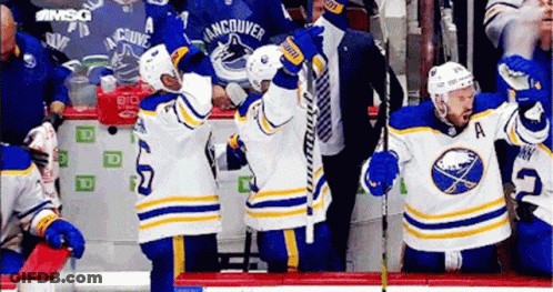 Hockey Players Sitting On Bench GIF