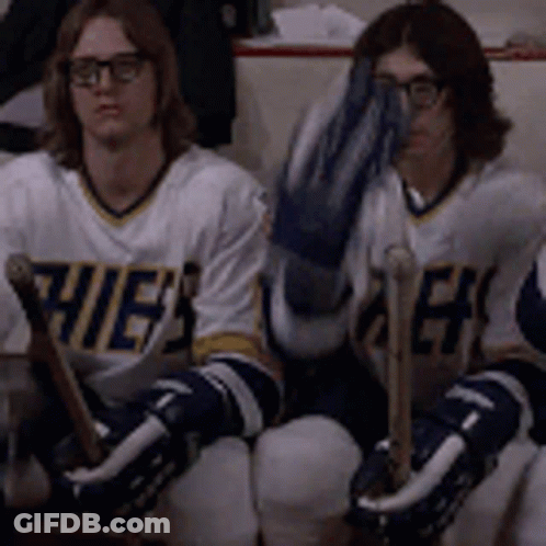 Hockey Players Sitting On Bench One Covering Face GIF