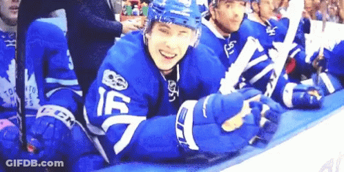 Hockey Players Sitting On Bench Smiling GIF