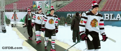 Hockey Players Walking Down Snowy Rink GIF