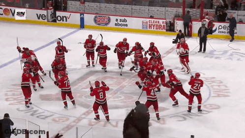 Hockey Team Celebrating Under Hydra Banner GIF