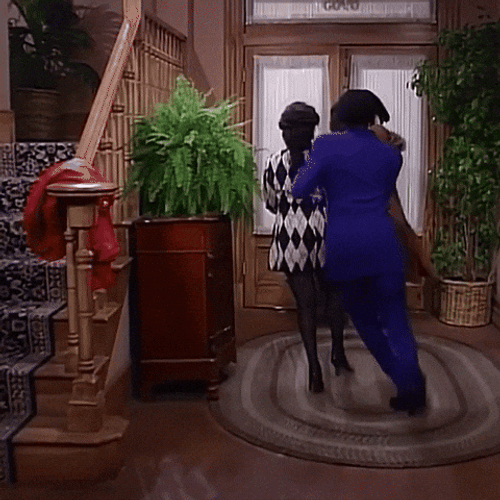 Holding Back Woman To Leave GIF