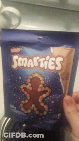 Holding Bag Of Smarties Candy GIF