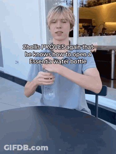 Hollis Opening Essentia Water Bottle At Table GIF