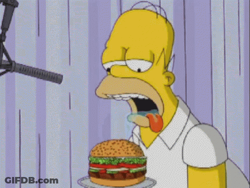 Homer Simpson Eating Hamburger In Front Of Microphone GIF