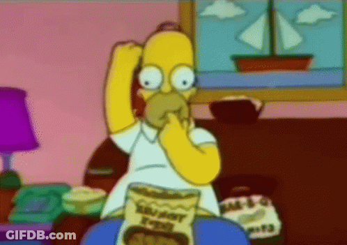 Homer Simpson From The Simpsons Is Eating A Bag Of Crunchy Potato Chips GIF