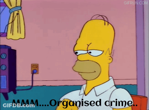 Homer Simpson From The Simpsons Is Sitting In Front Of A Tv And Says " Organised Crime " GIF