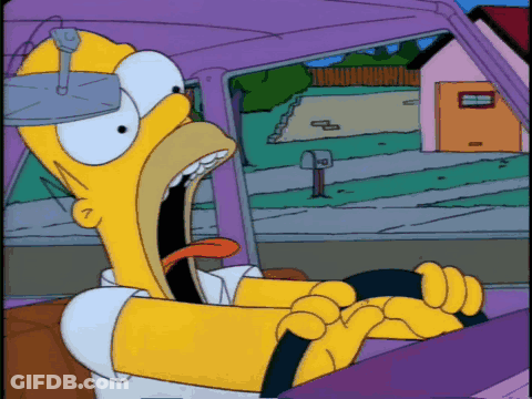 Homer Simpson Is Driving A Car With His Mouth Open And His Tongue Sticking Out GIF