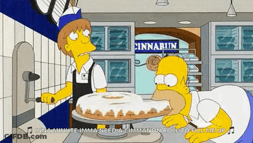 Homer Simpson Is Eating A Cinnamon Roll In A Bakery GIF