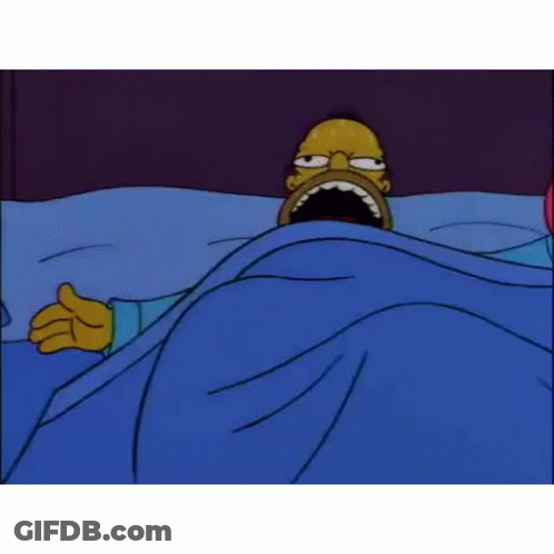Homer Simpson Is Laying In A Bed With His Mouth Open . GIF