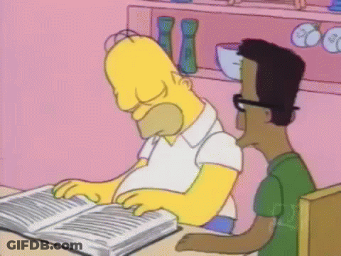 Homer Simpson Is Reading A Book While Sitting At A Table With A Man . GIF