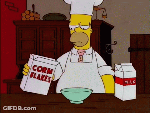 Homer Simpson Is Reading A Box Of Corn Flakes GIF