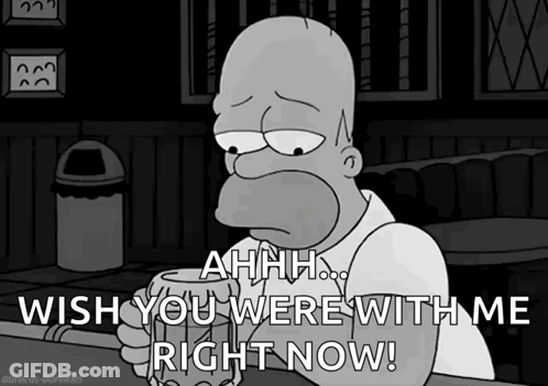 Homer Simpson Is Sitting At A Bar Holding A Beer And Saying " Ahhh Wish You Were With Me Right Now " GIF
