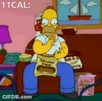 Homer Simpson Is Sitting On A Couch Eating A Bag Of Crunchy Peanut Butter GIF