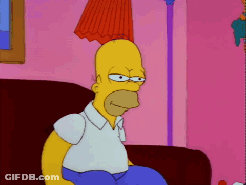 Homer Simpson Sitting On Couch In Pink Room GIF
