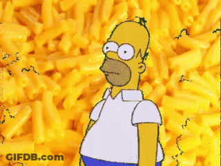 Homer Simpson Is Standing In Front Of A Pile Of Macaroni Cheese GIF