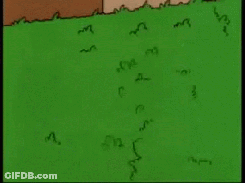 Homer Simpson Is Standing In The Grass Looking At Something . GIF