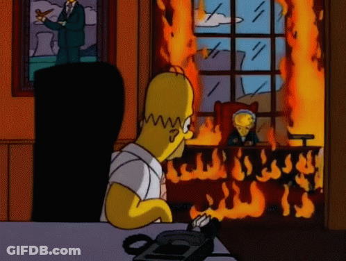 Homer Simpson Sits In Front Of A Burning Building GIF