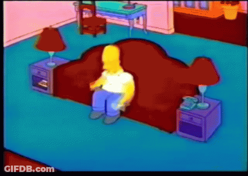 Homer Simpson Sits On A Red Couch In A Living Room GIF