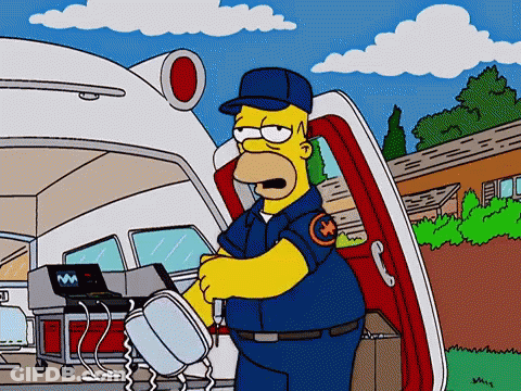 Homer Simpson Talking On Cell Phone In Front Of Ambulance GIF