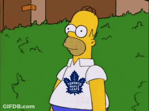 Homer Simpson Wearing A Toronto Raptors Shirt Stands In The Grass GIF