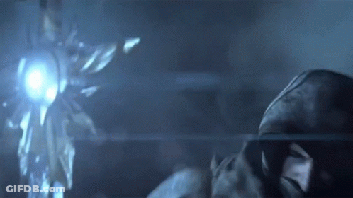 Hooded Man Backlit In Dark Room GIF