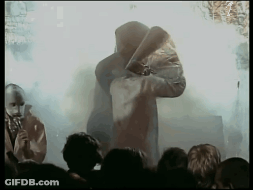 Hooded Man Holding Sword Before Crowd GIF