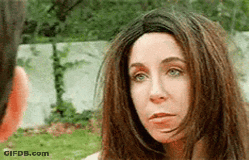 Hooded Man With Bow And Arrow Holding Hand On Chest GIF