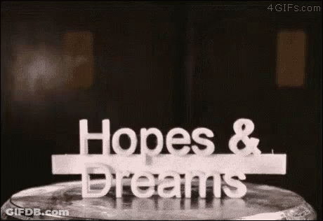 Hopes And Dreams Sign On Wooden Table GIF